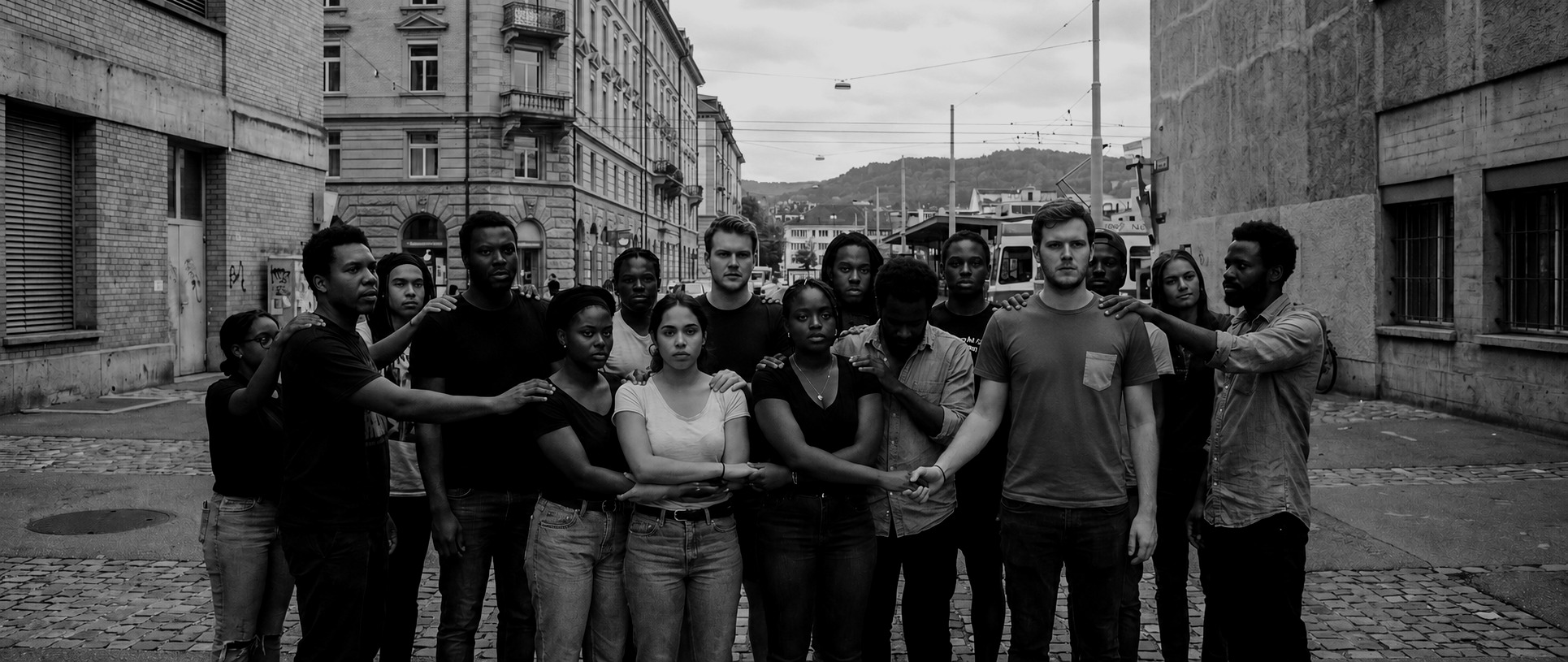 A community group standing together in an urban street